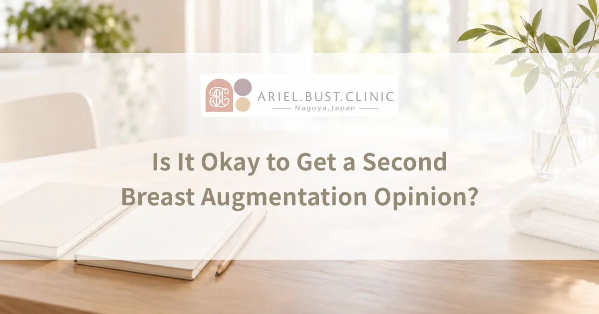 Two open notebooks beside a folded cream towel and a glass vase in a bright room, ready for comparing breast augmentation proposals.